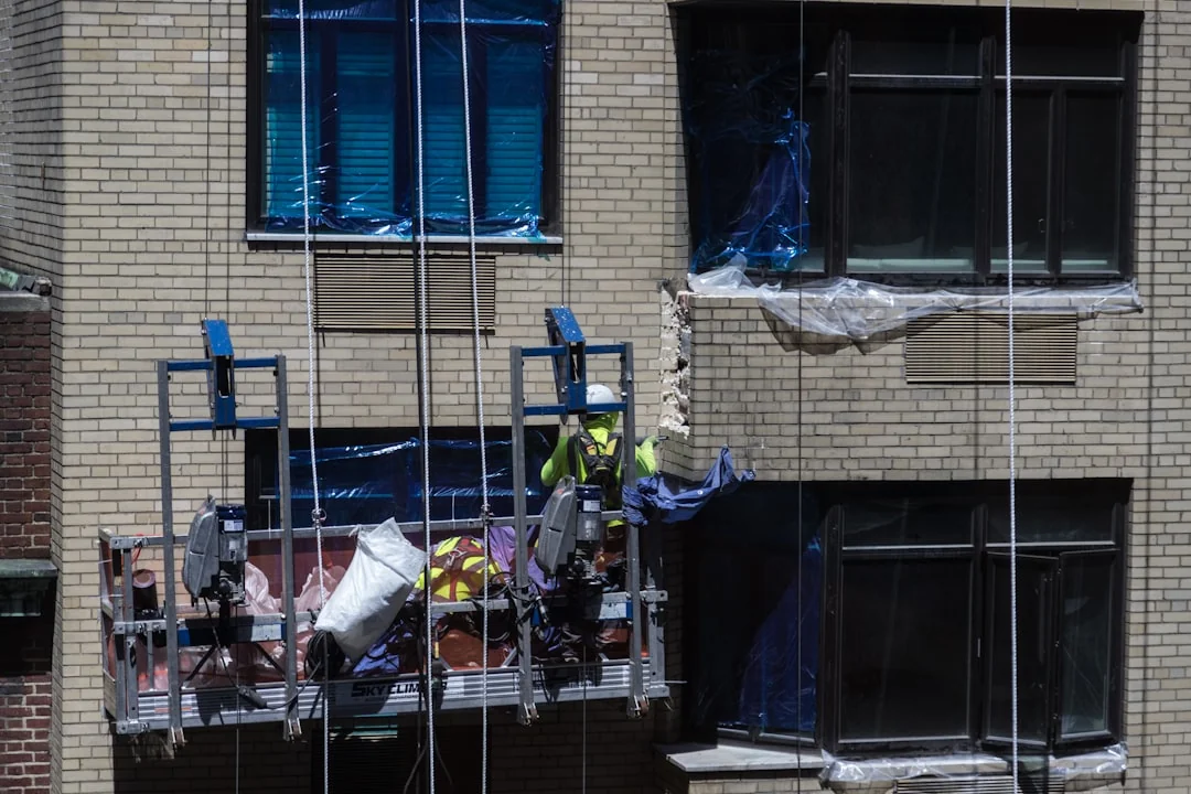 A worker in protective gear disinfects a kitchen, ensuring a clean and safe environment.